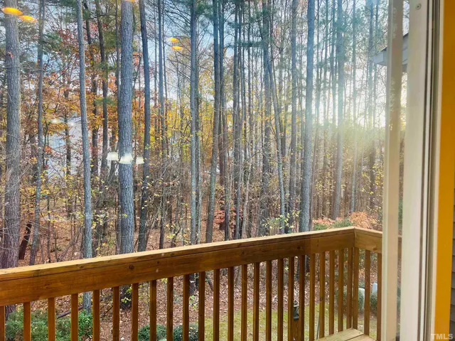 a view of a balcony with trees
