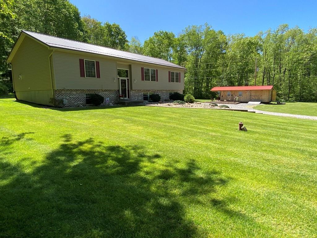 138 Center Church Road Polk, PA 16342 - Photo 1 of 64 a view of a backyard with plants and a patio