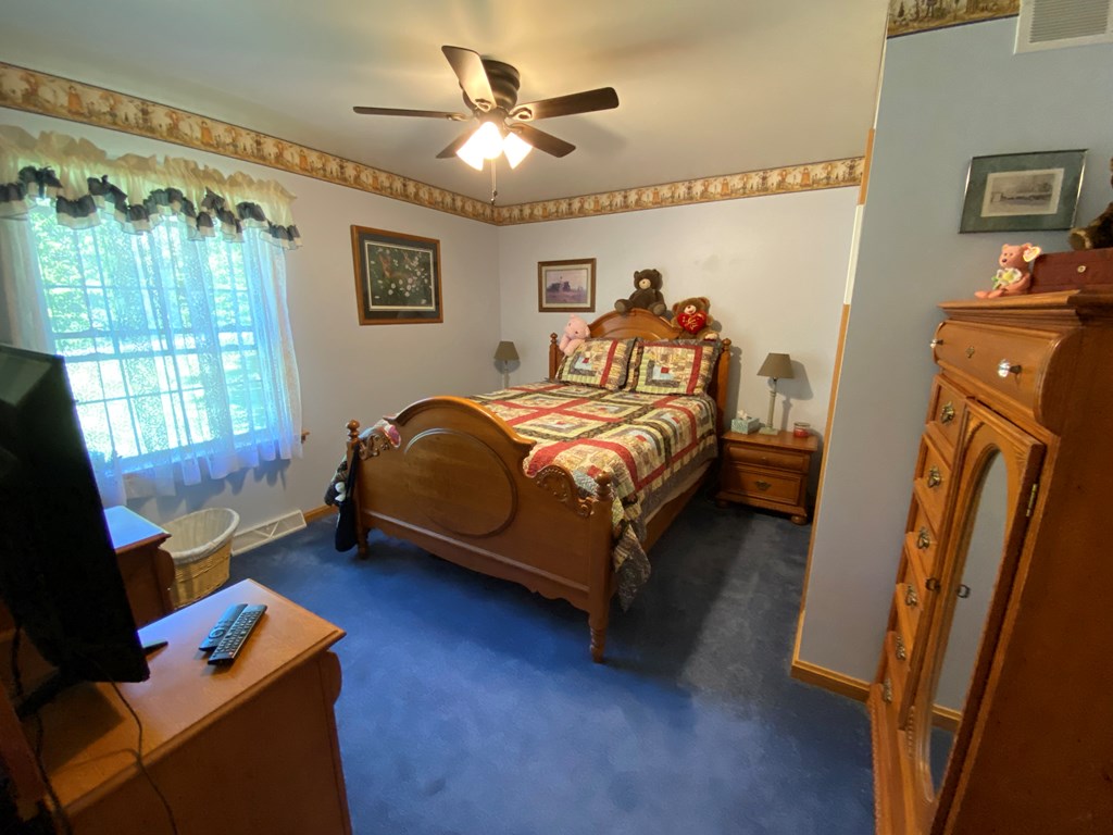 138 Center Church Road Polk, PA 16342 - Photo 18 of 64 a bed room with a bed window and a chair