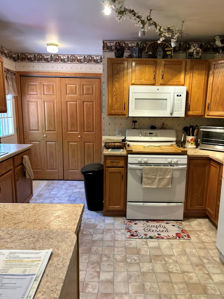 138 Center Church Road Polk, PA 16342 - Photo 25 of 64 a kitchen with stainless steel appliances granite countertop a stove a sink and a refrigerator