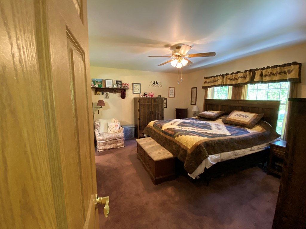 138 Center Church Road Polk, PA 16342 - Photo 30 of 64 a bedroom with a bed and a chandelier