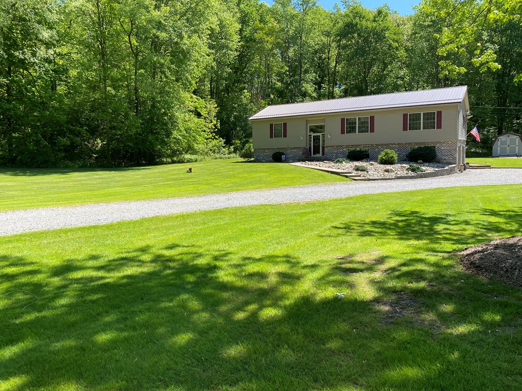 138 Center Church Road Polk, PA 16342 - Photo 53 of 64 a front view of a house with garden and trees