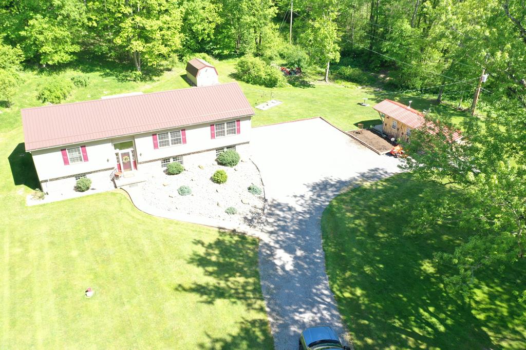 138 Center Church Road Polk, PA 16342 - Photo 58 of 64 an aerial view of a house with a yard and large trees