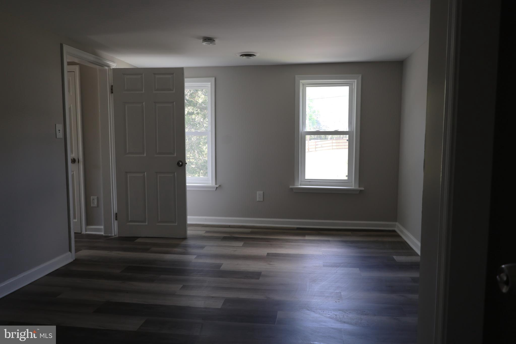 6213 Appletown Road Boonsboro, MD 21713 - Photo 14 of 18 an empty room with wooden floor and windows