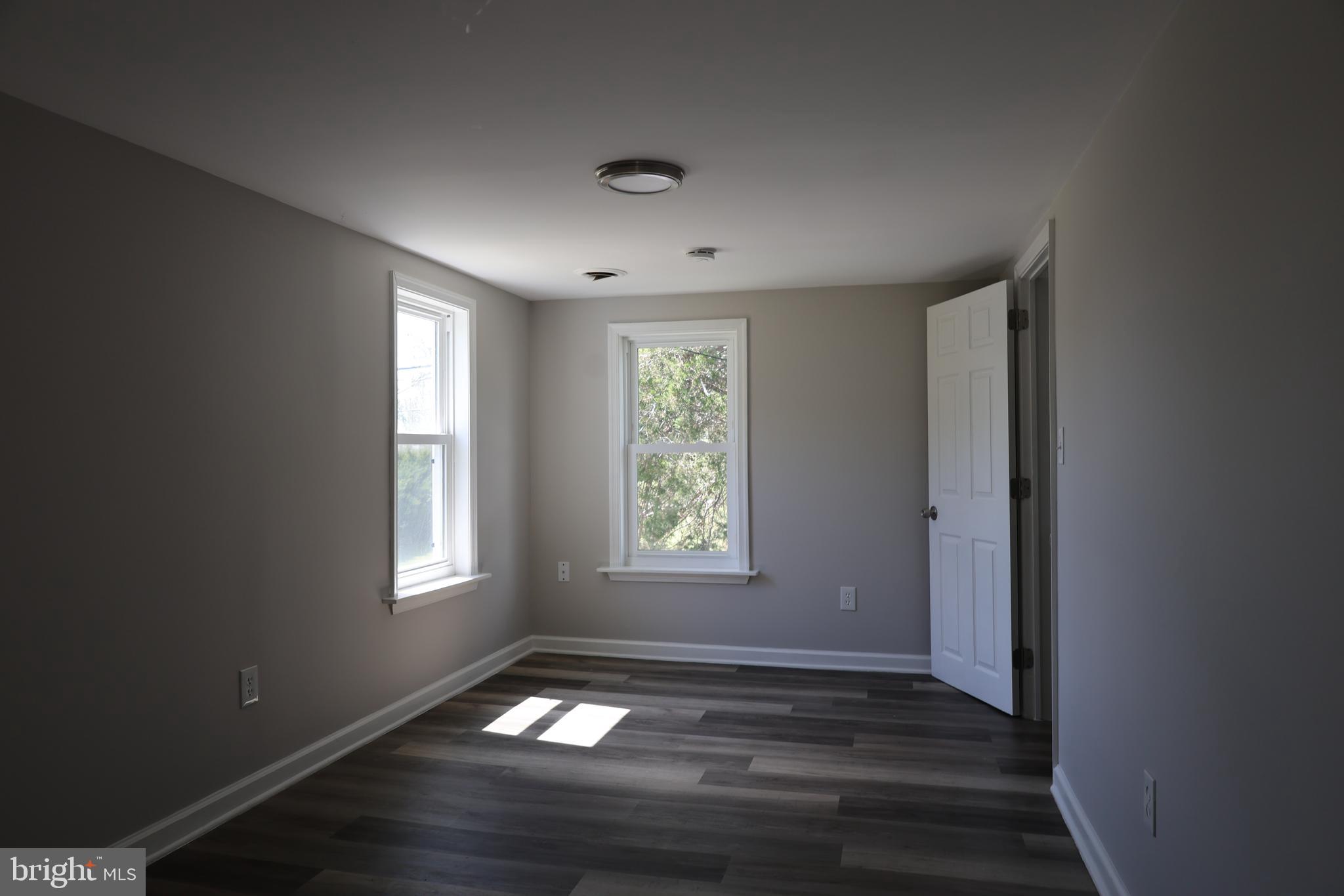 6213 Appletown Road Boonsboro, MD 21713 - Photo 17 of 18 a view of an empty room with wooden floor and a window