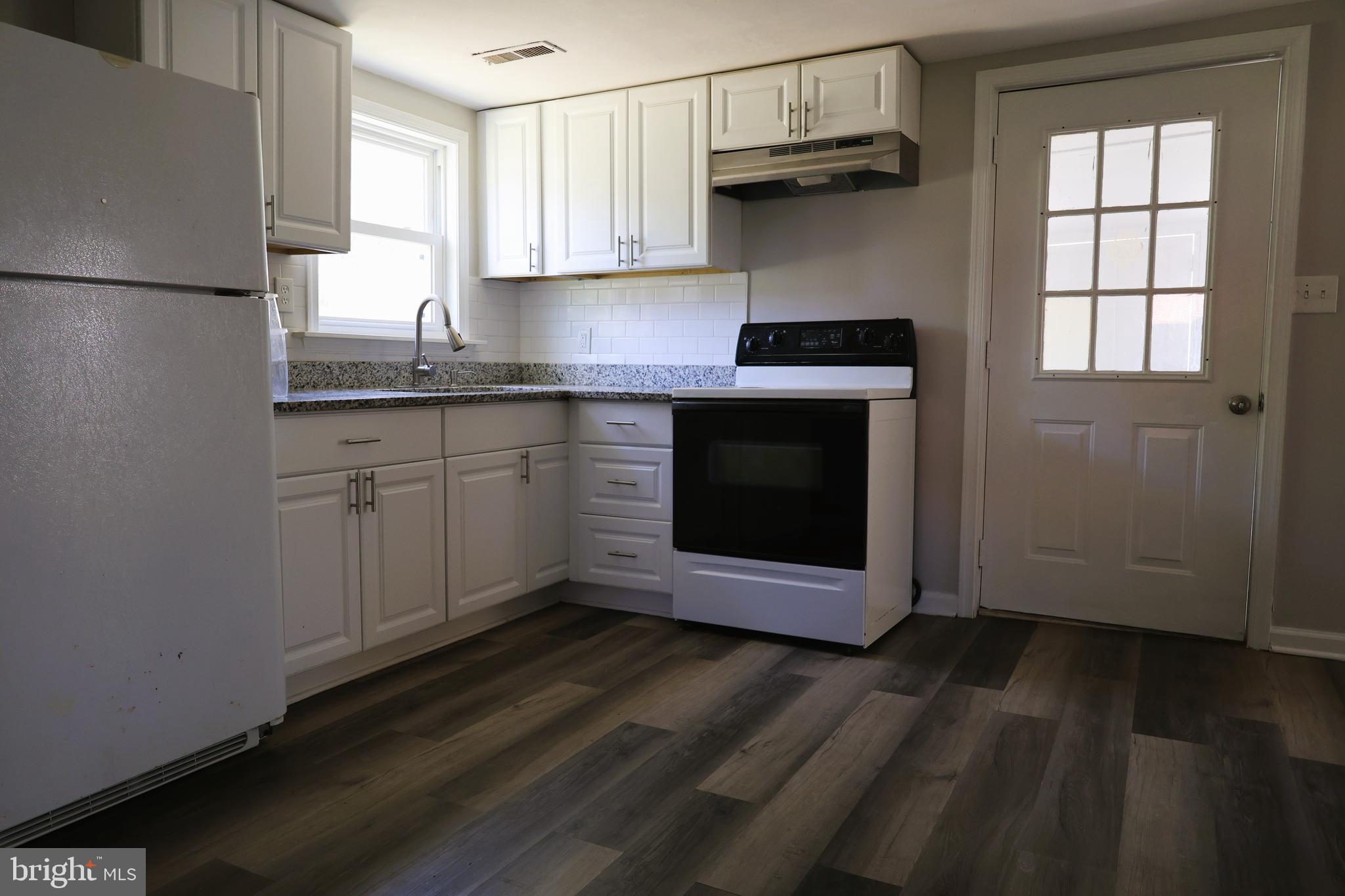 6213 Appletown Road Boonsboro, MD 21713 - Photo 7 of 18 a kitchen with granite countertop cabinets stainless steel appliances and a window