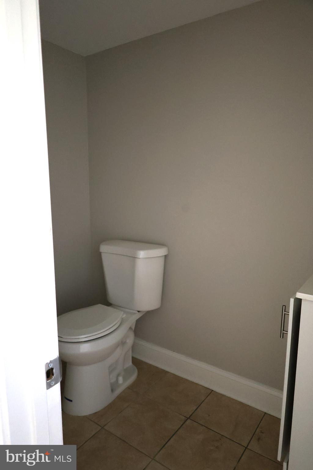 6213 Appletown Road Boonsboro, MD 21713 - Photo 10 of 18 a white toilet sitting next to a white sink and vanity