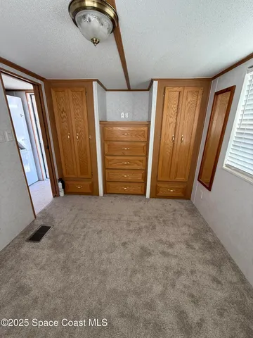 a view of a kitchen with furniture and a large window