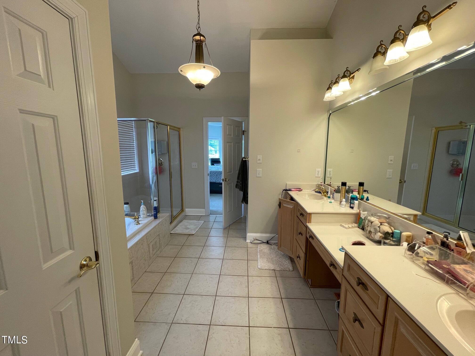 551 Competition Road Raleigh, NC 27603 - Photo 17 of 37 a spacious bathroom with a double vanity sink a mirror and a shower
