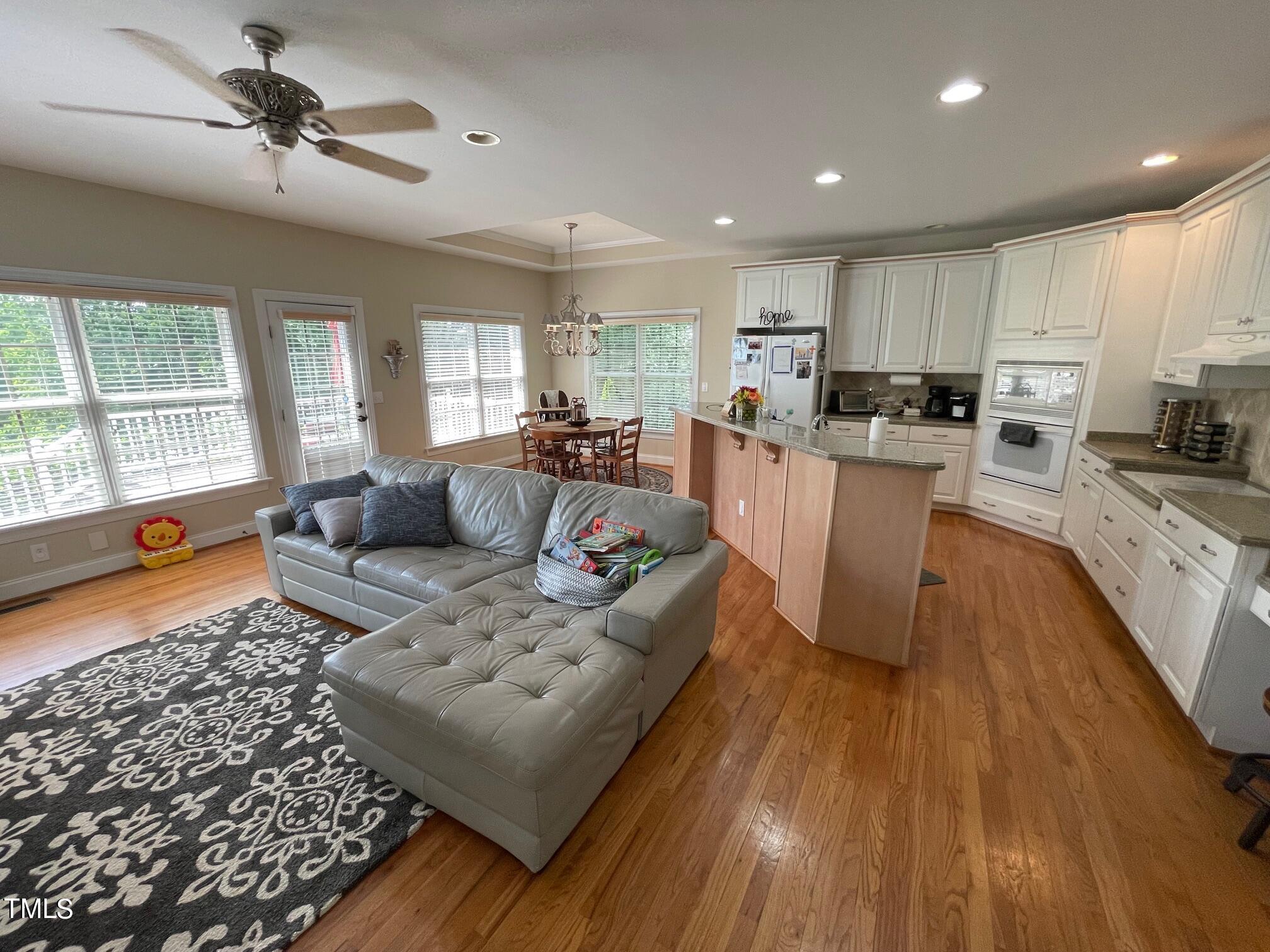 551 Competition Road Raleigh, NC 27603 - Photo 21 of 37 a living room with furniture and a wooden floor