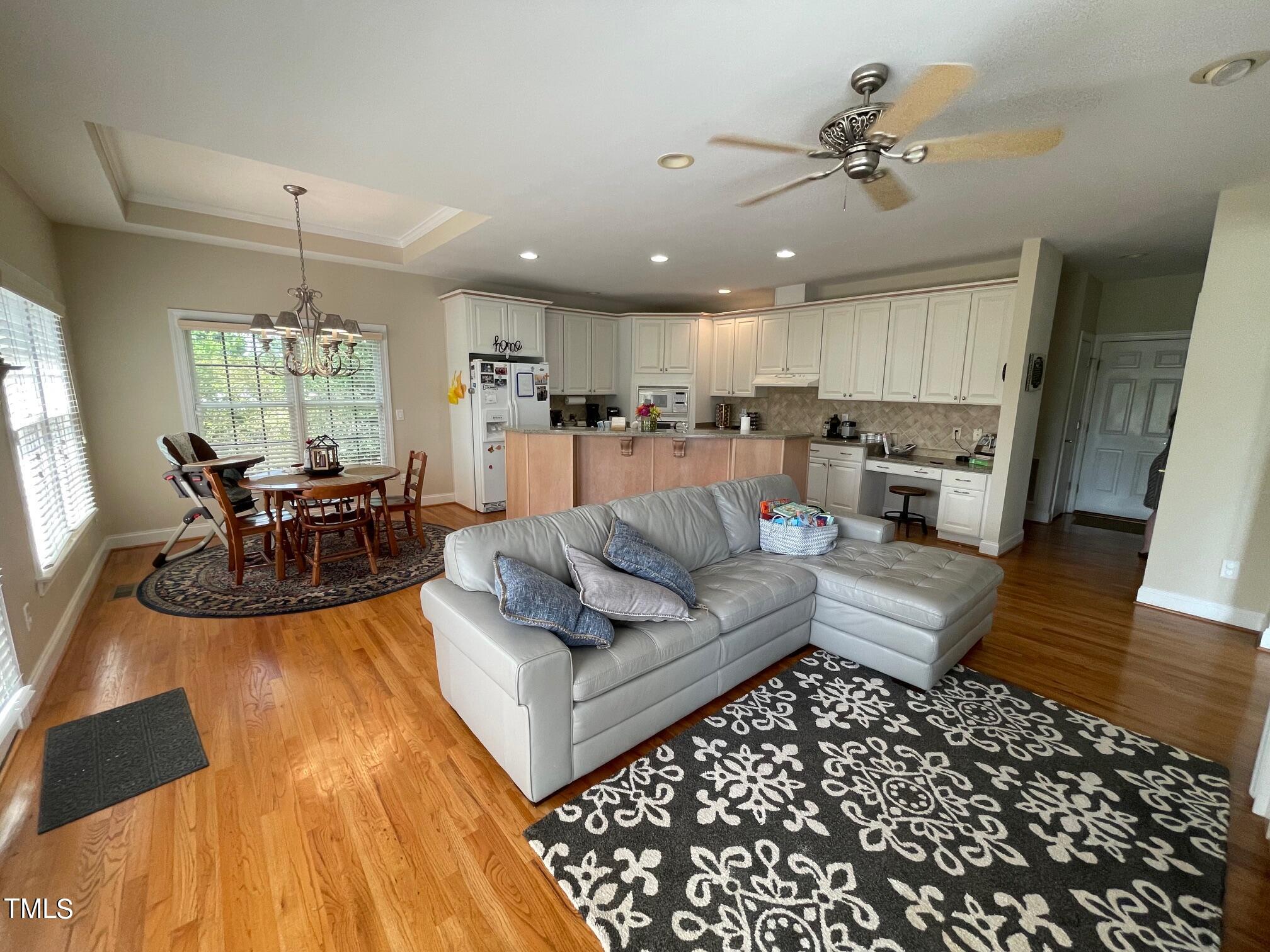 551 Competition Road Raleigh, NC 27603 - Photo 25 of 37 a living room with furniture and a chandelier