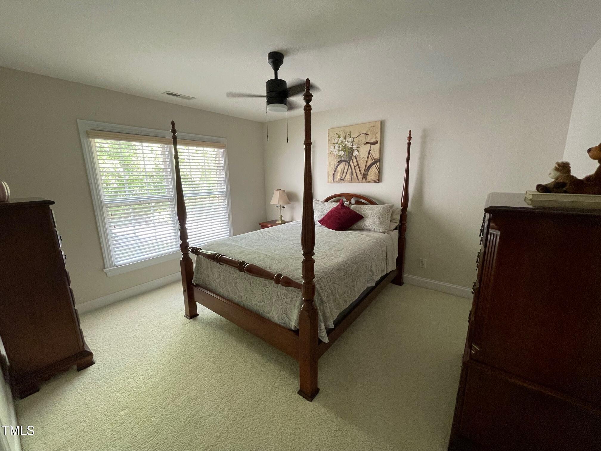 551 Competition Road Raleigh, NC 27603 - Photo 33 of 37 a bedroom with a bed and a night stand