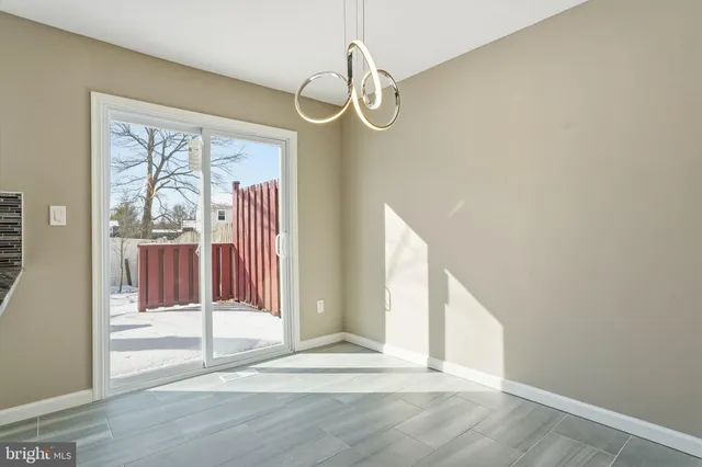 a view of a room with wooden floor and windows
