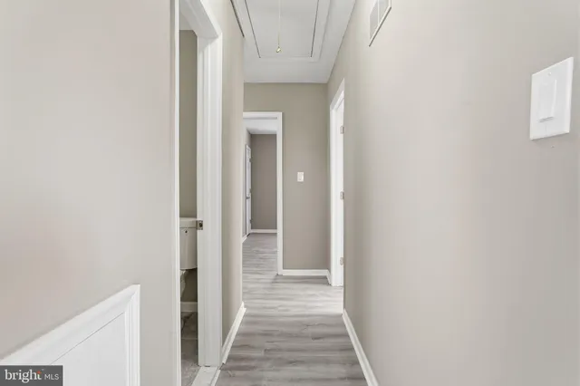 a view of a hallway with wooden floor
