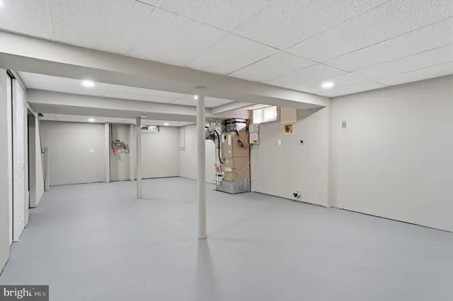 a front view of a house with a yard covered with snow