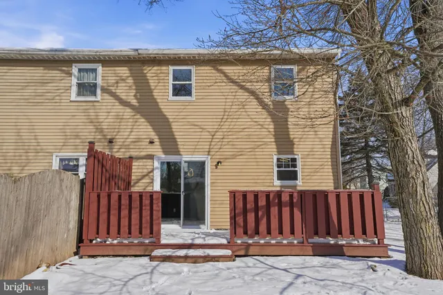 a view of a house with a wooden fence