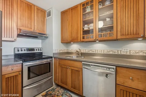 a kitchen with a stove top oven and refrigerator