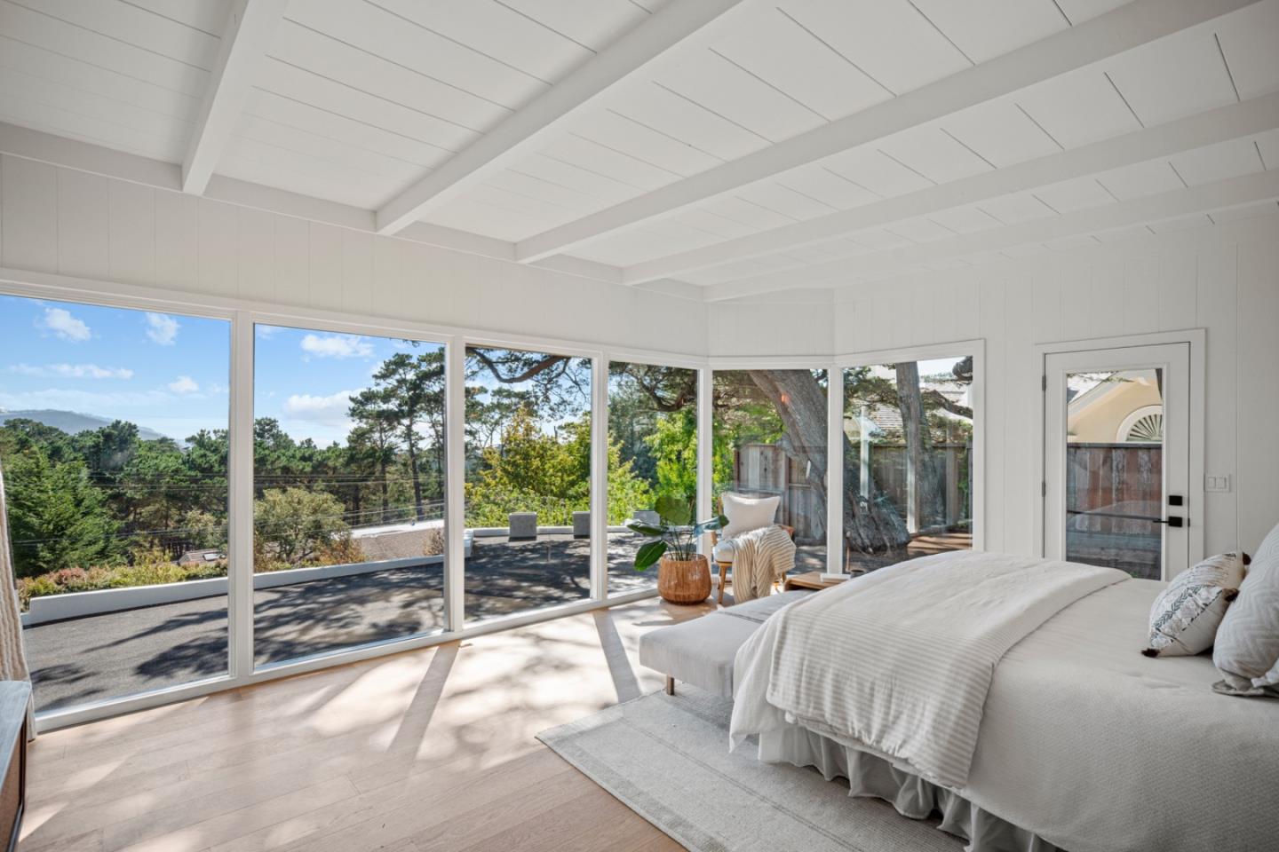 4171 Sunset Lane Pebble Beach, CA 93953 - Photo 18 of 38 a bedroom with a large bed and a large window with outer view