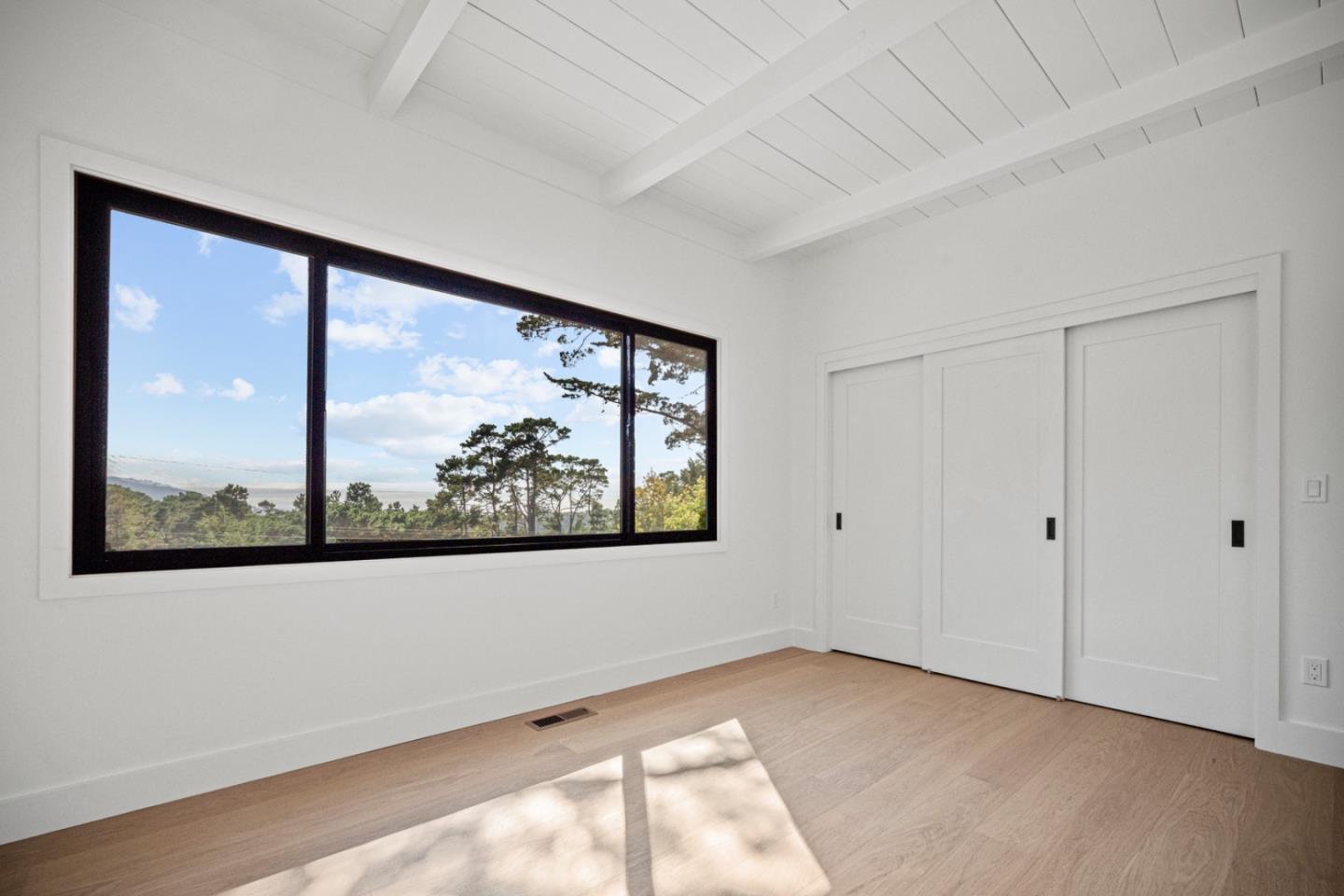 4171 Sunset Lane Pebble Beach, CA 93953 - Photo 28 of 38 a view of a big room with wooden floor and windows