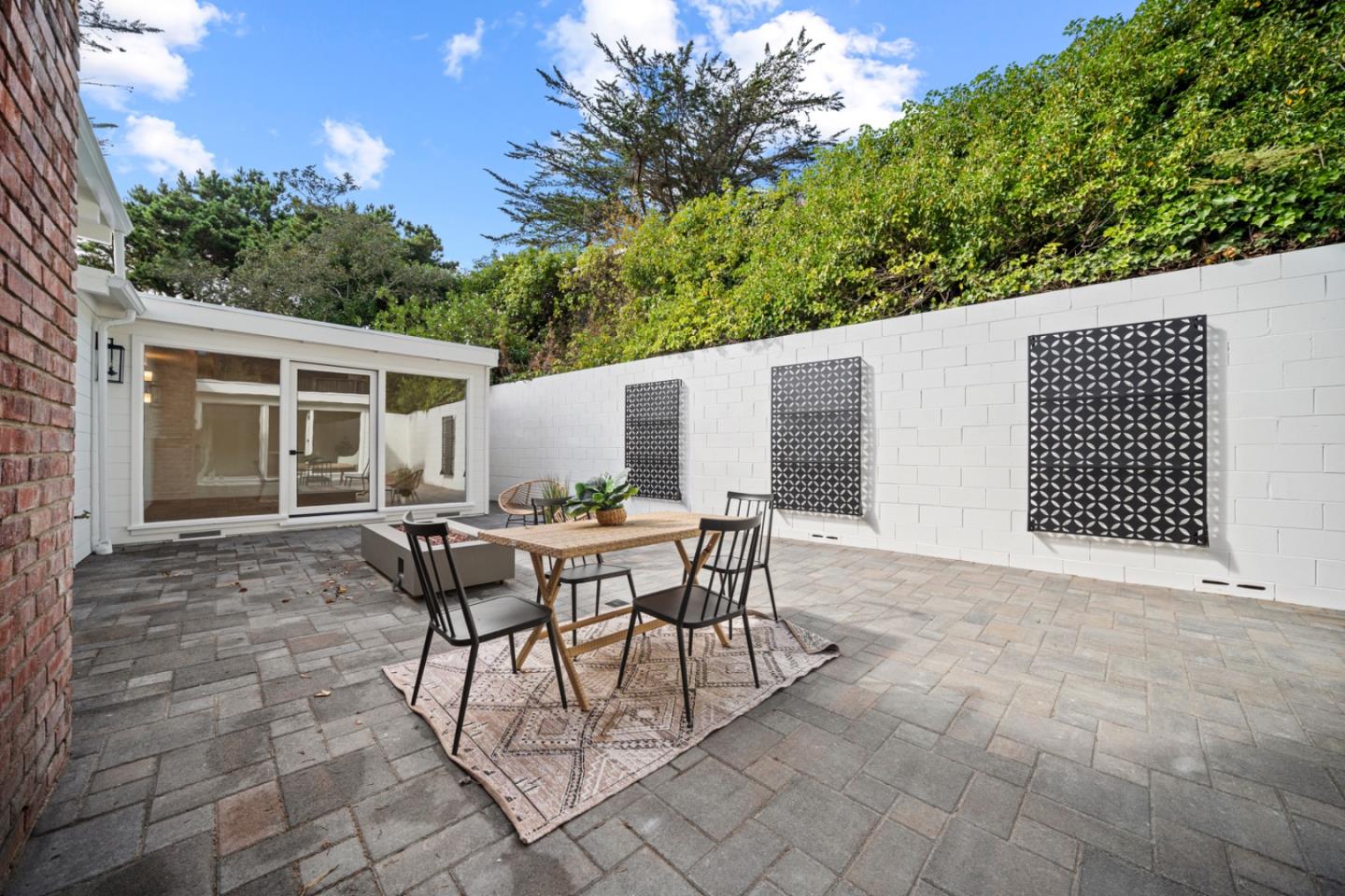 4171 Sunset Lane Pebble Beach, CA 93953 - Photo 32 of 38 a backyard of a house with table and chairs