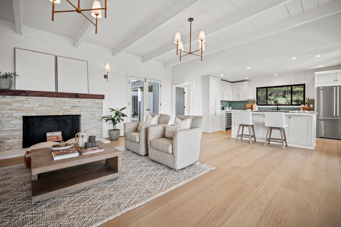 4171 Sunset Lane Pebble Beach, CA 93953 - Photo 6 of 38 a living room with furniture and a fireplace with kitchen view