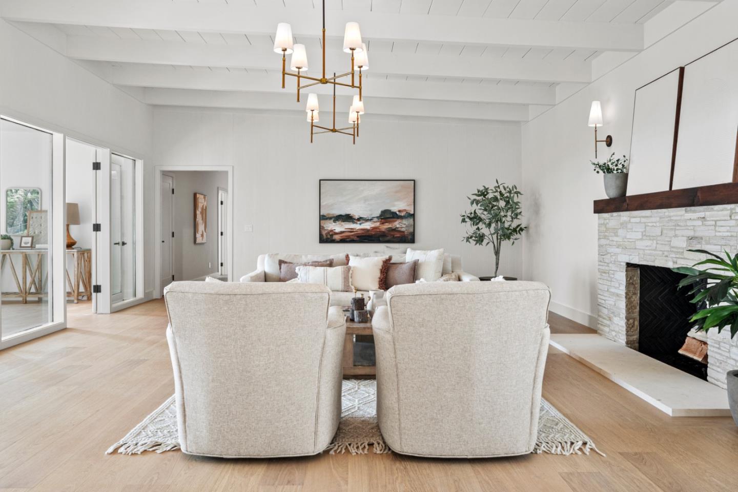 4171 Sunset Lane Pebble Beach, CA 93953 - Photo 8 of 38 a living room with couches a fireplace and a chandelier