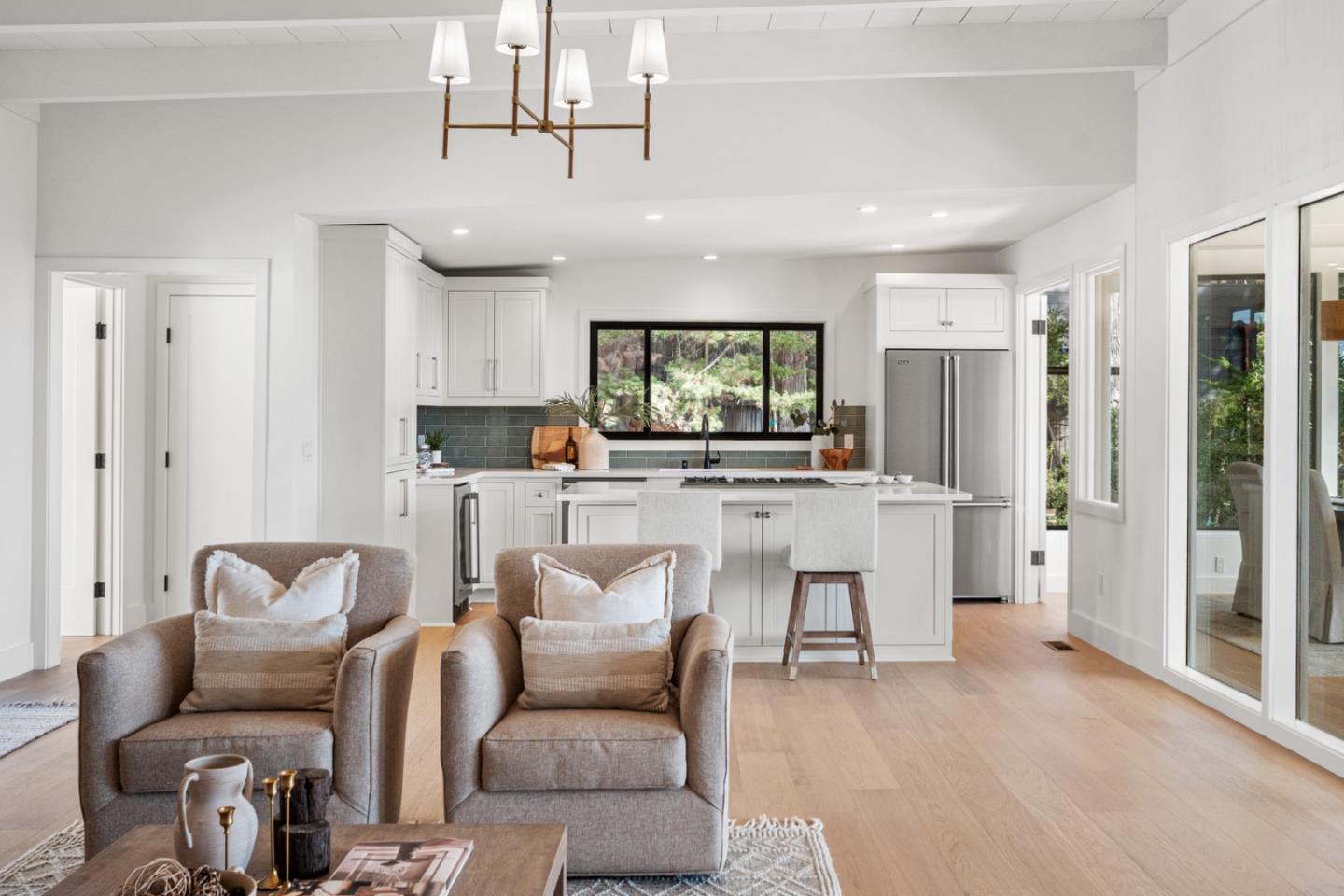 4171 Sunset Lane Pebble Beach, CA 93953 - Photo 10 of 38 a living room with furniture a dining table and kitchen view