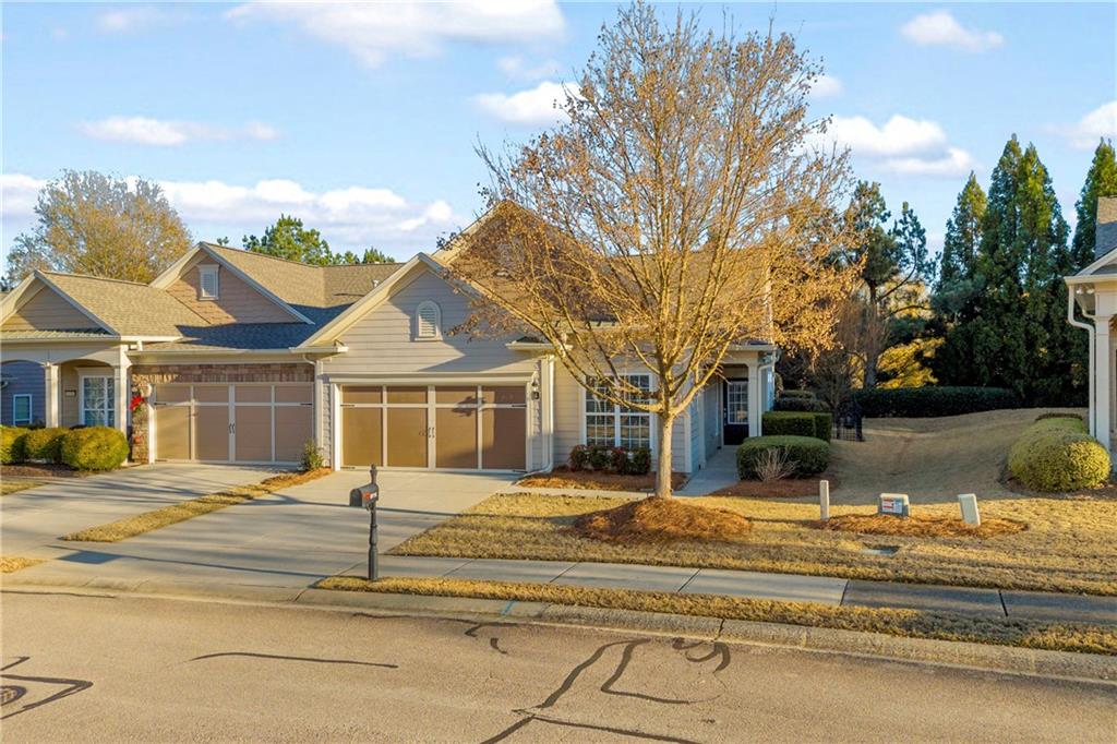 6116 Longleaf Drive Hoschton, GA 30548 - Photo 2 of 46 a view of a white house with a large tree
