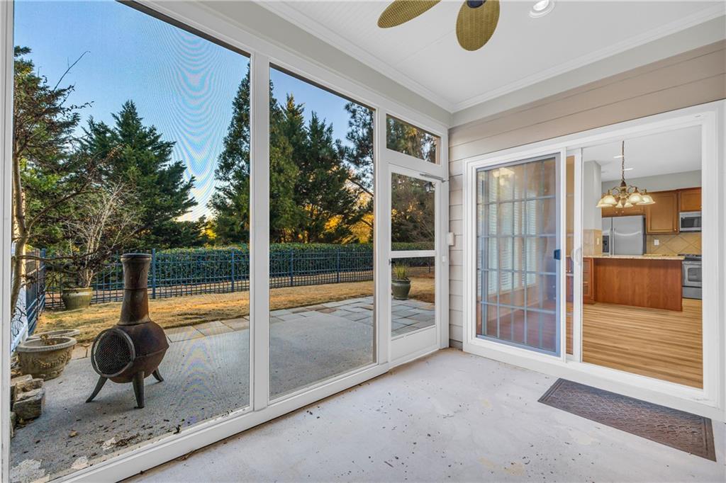 6116 Longleaf Drive Hoschton, GA 30548 - Photo 25 of 46 a view of a porch with a floor to ceiling window and wooden floor
