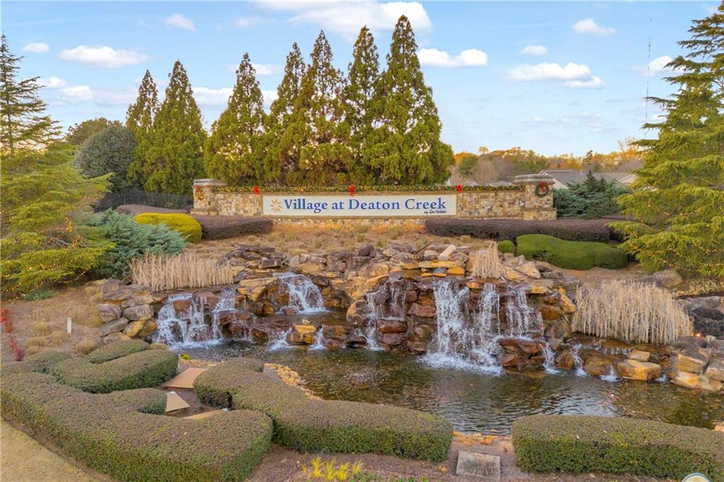 6116 Longleaf Drive Hoschton, GA 30548 - Photo 39 of 46 a view of a lake with couches and city view