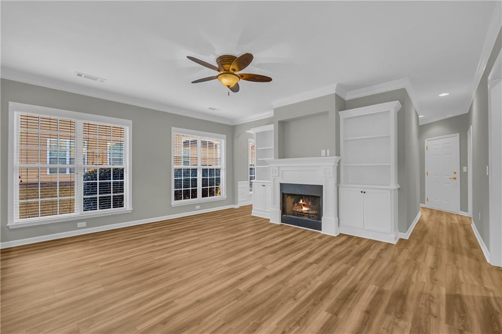 6116 Longleaf Drive Hoschton, GA 30548 - Photo 8 of 46 a view of a livingroom with a fireplace and a window