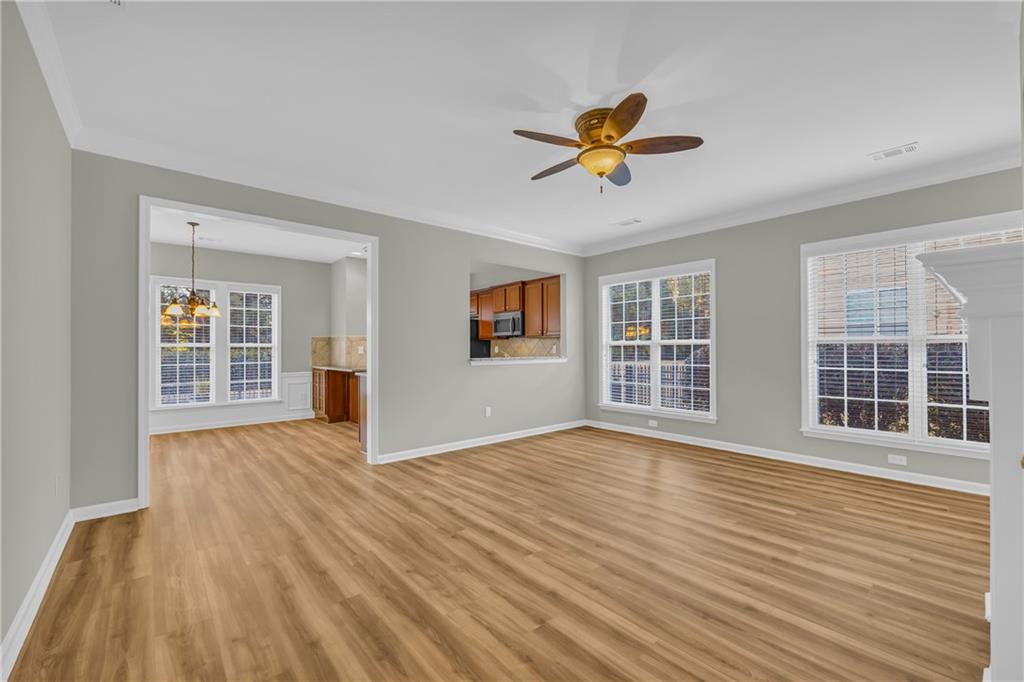6116 Longleaf Drive Hoschton, GA 30548 - Photo 9 of 46 a view of empty room with wooden floor and window