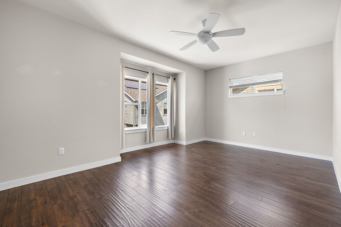 5616 South 1st Street, Unit 31 Austin, TX 78745 - Photo 11 of 21 wooden floor in an empty room with a window