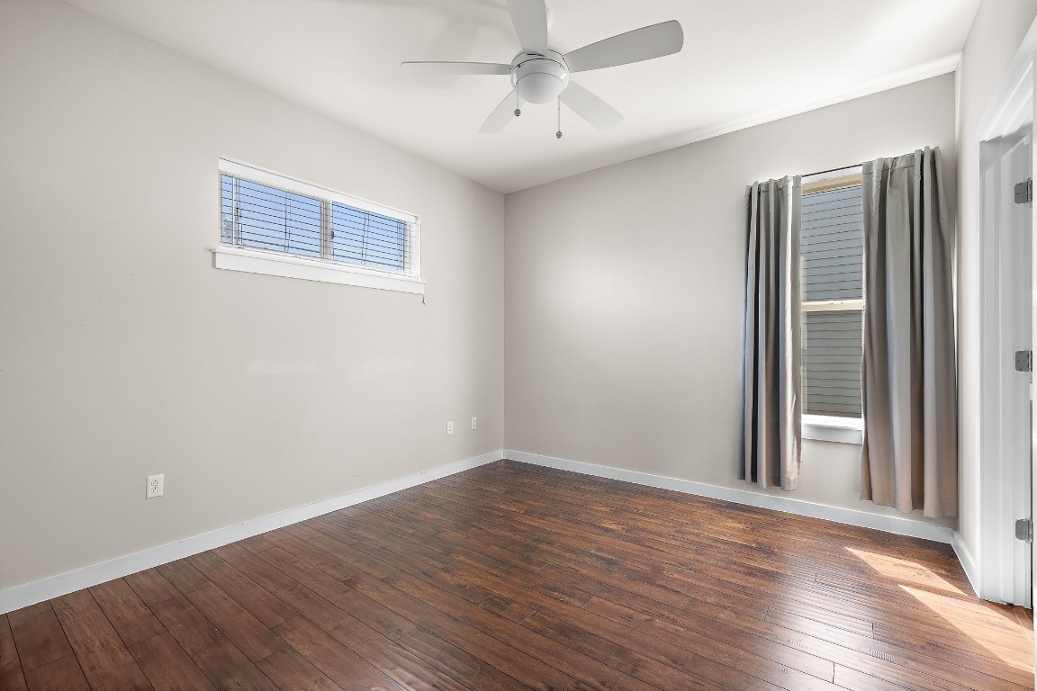 5616 South 1st Street, Unit 31 Austin, TX 78745 - Photo 14 of 21 a view of an empty room with wooden floor and a window