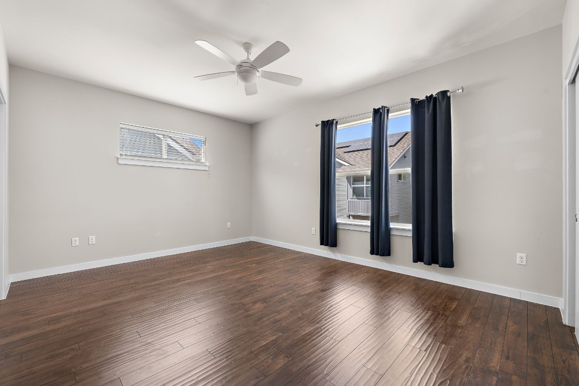 5616 South 1st Street, Unit 31 Austin, TX 78745 - Photo 17 of 21 a view of an empty room with wooden floor and a window
