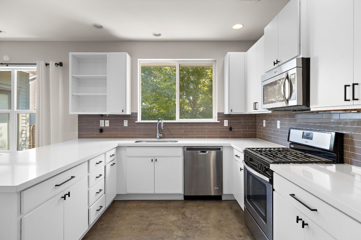5616 South 1st Street, Unit 31 Austin, TX 78745 - Photo 7 of 21 a kitchen with a sink stove cabinets and a window