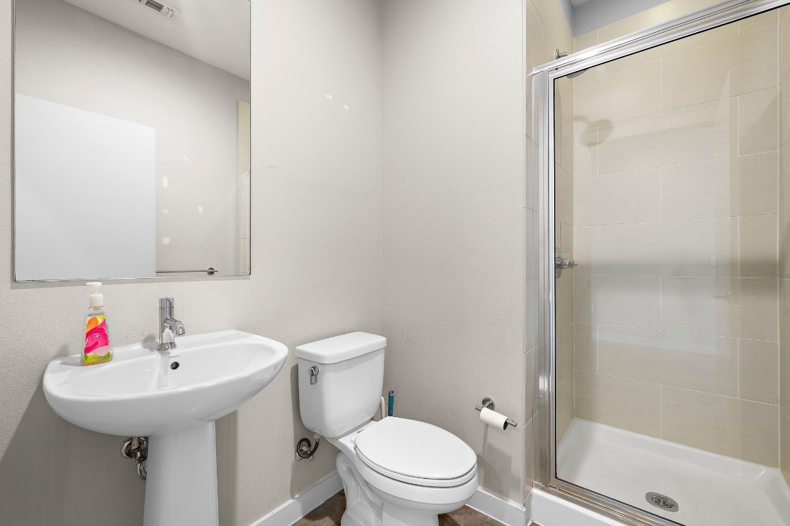 5616 South 1st Street, Unit 31 Austin, TX 78745 - Photo 10 of 21 a white toilet sitting next to a bathroom sink