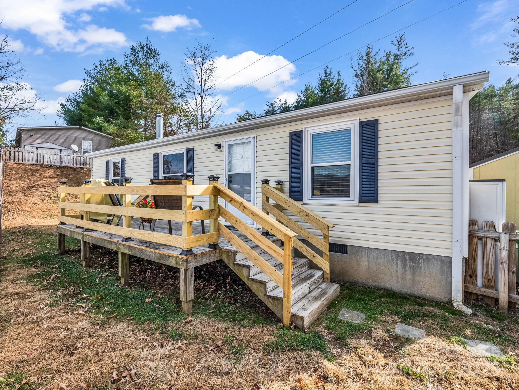106 Hazy Day Swannanoa, NC 28778 - Photo 25 of 30 a backyard of a house with wooden deck and outdoor seating
