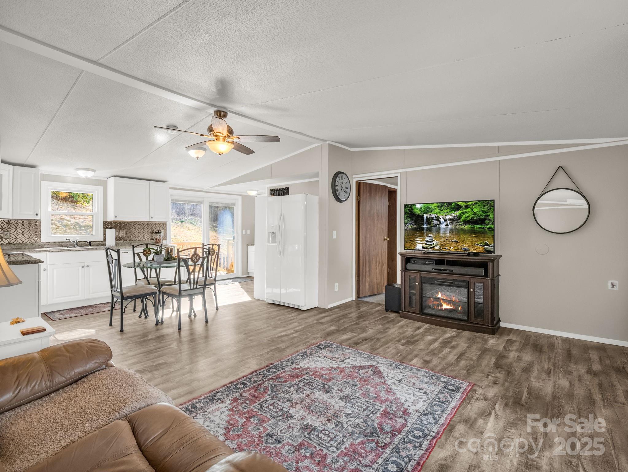 106 Hazy Day Swannanoa, NC 28778 - Photo 3 of 30 a living room with furniture a dining table and a fireplace