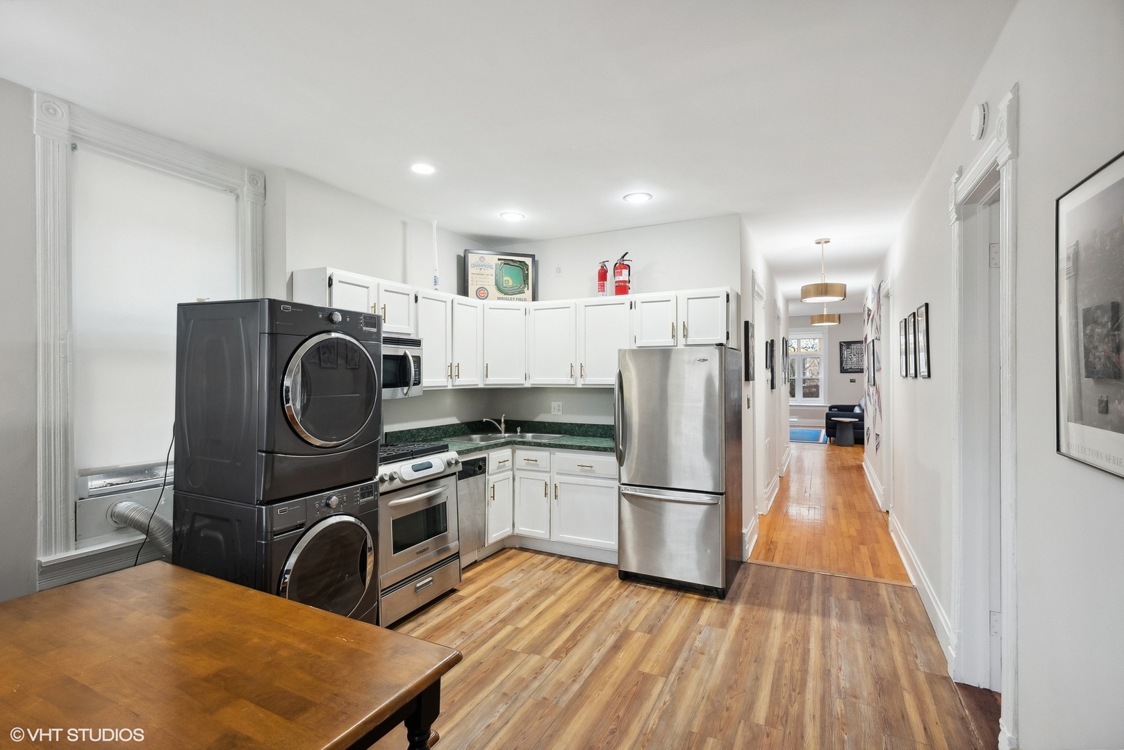 Undisclosed Address Chicago, IL 60657 - Photo 11 of 13 a kitchen with granite countertop a refrigerator a stove top oven and wooden floor
