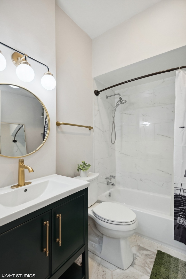 Undisclosed Address Chicago, IL 60657 - Photo 7 of 13 a bathroom with a sink a toilet and a mirror
