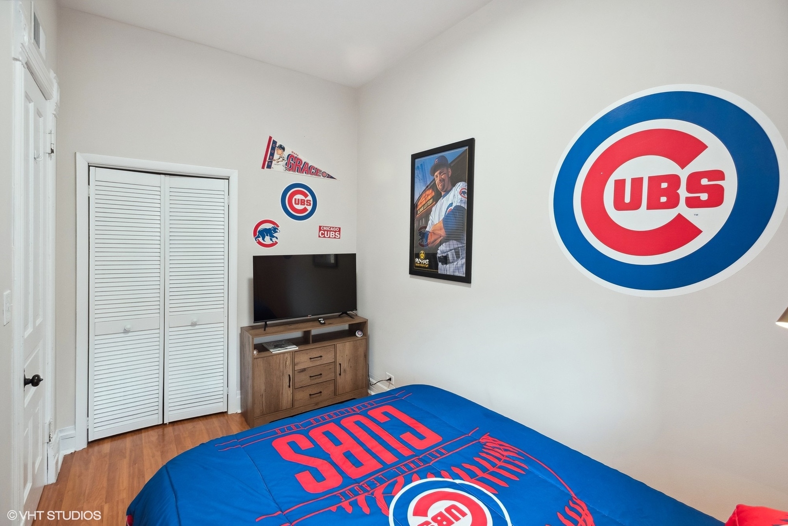 Undisclosed Address Chicago, IL 60657 - Photo 9 of 13 a room with a bed and a flat screen tv