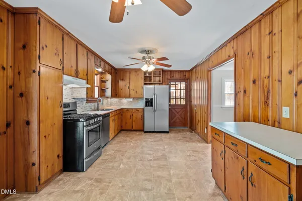 an aerial view of residential houses with outdoor space and trees