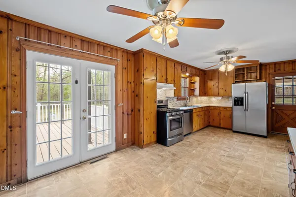 a view of an empty room with a fireplace and a window