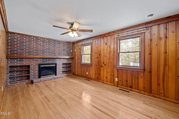 a view of a swimming pool with a patio and a yard