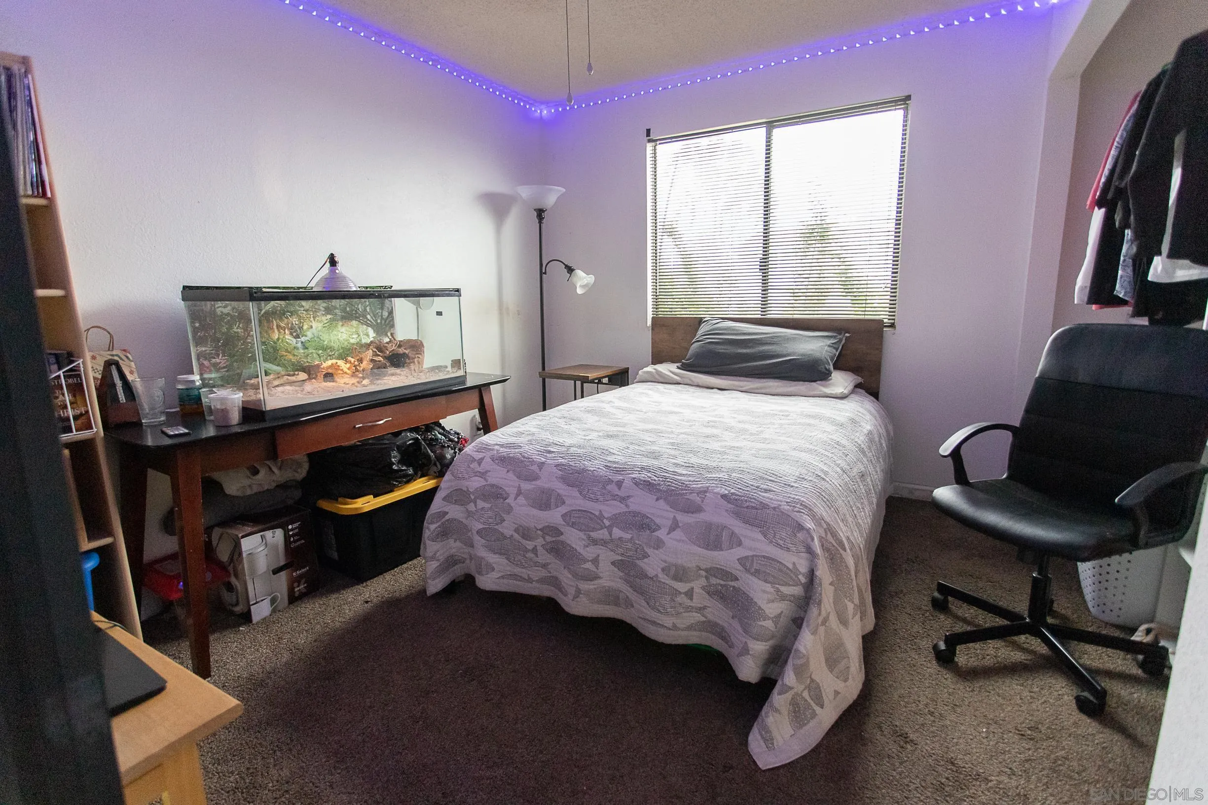 9802 Eucalyptus Street Spring Valley, CA 91977 - Photo 15 of 40 a bedroom with a bed a bookshelf and a flat screen tv