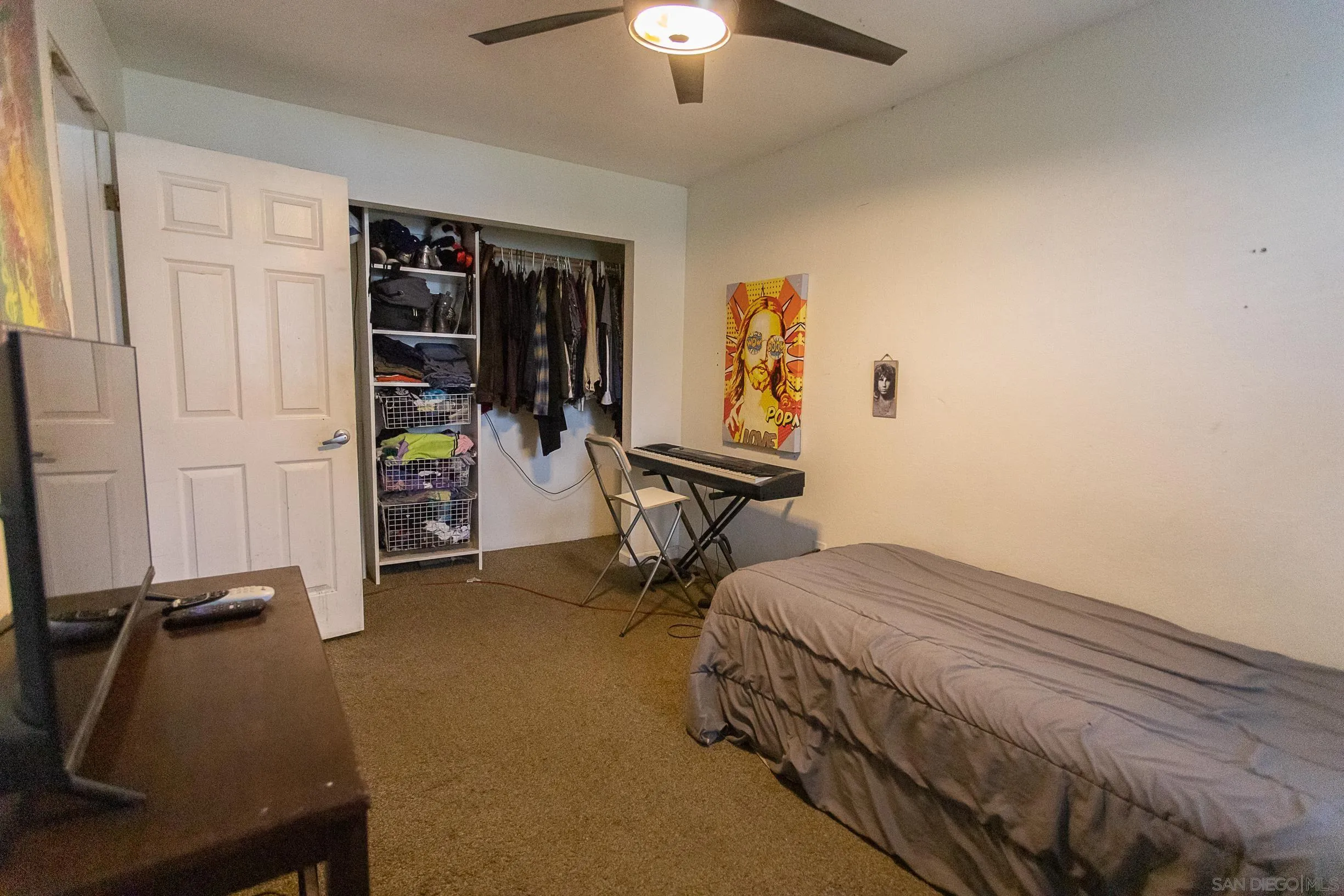 9802 Eucalyptus Street Spring Valley, CA 91977 - Photo 18 of 40 a bedroom with bed and a chandelier