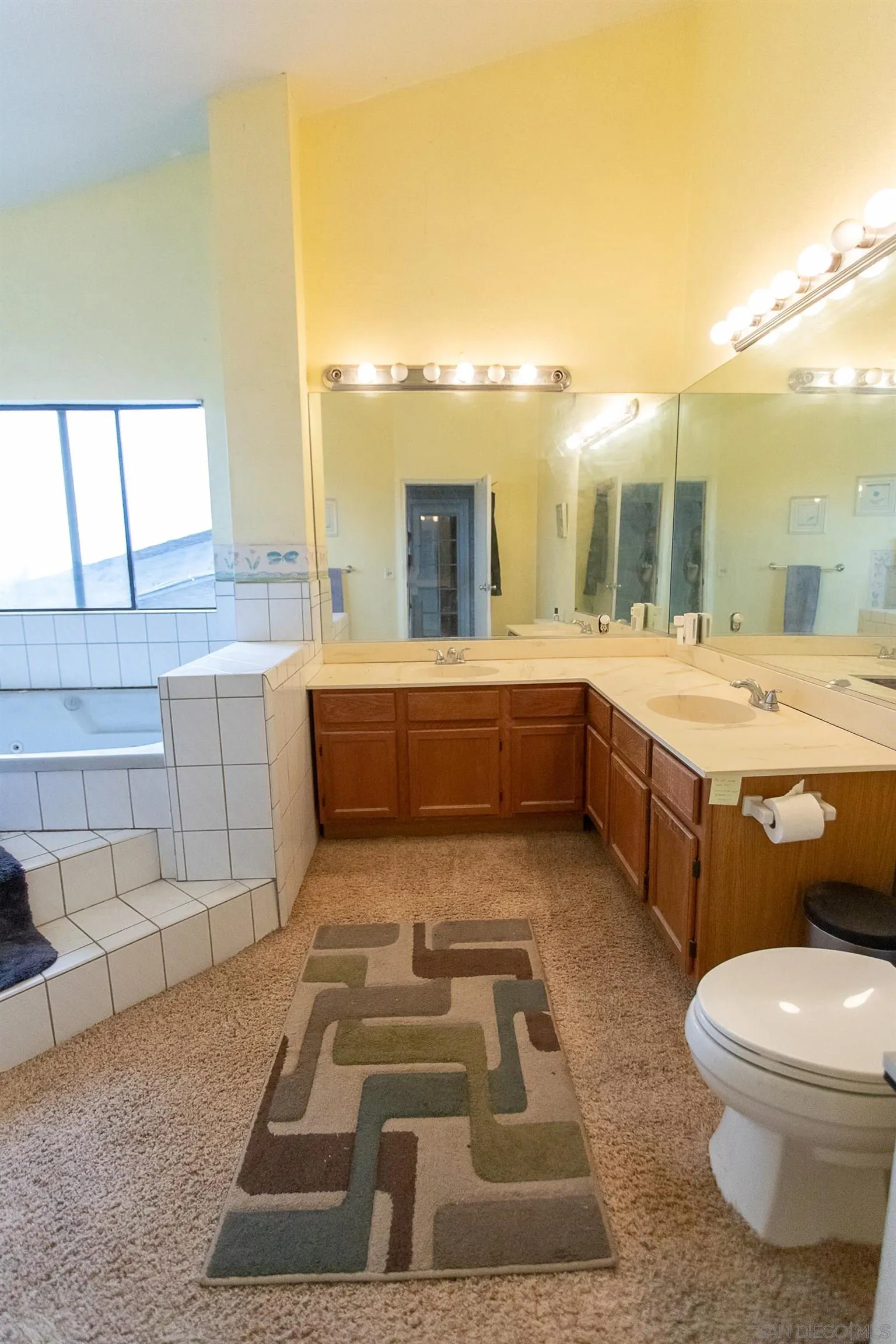 9802 Eucalyptus Street Spring Valley, CA 91977 - Photo 28 of 40 a bathroom with a tub sink and mirror