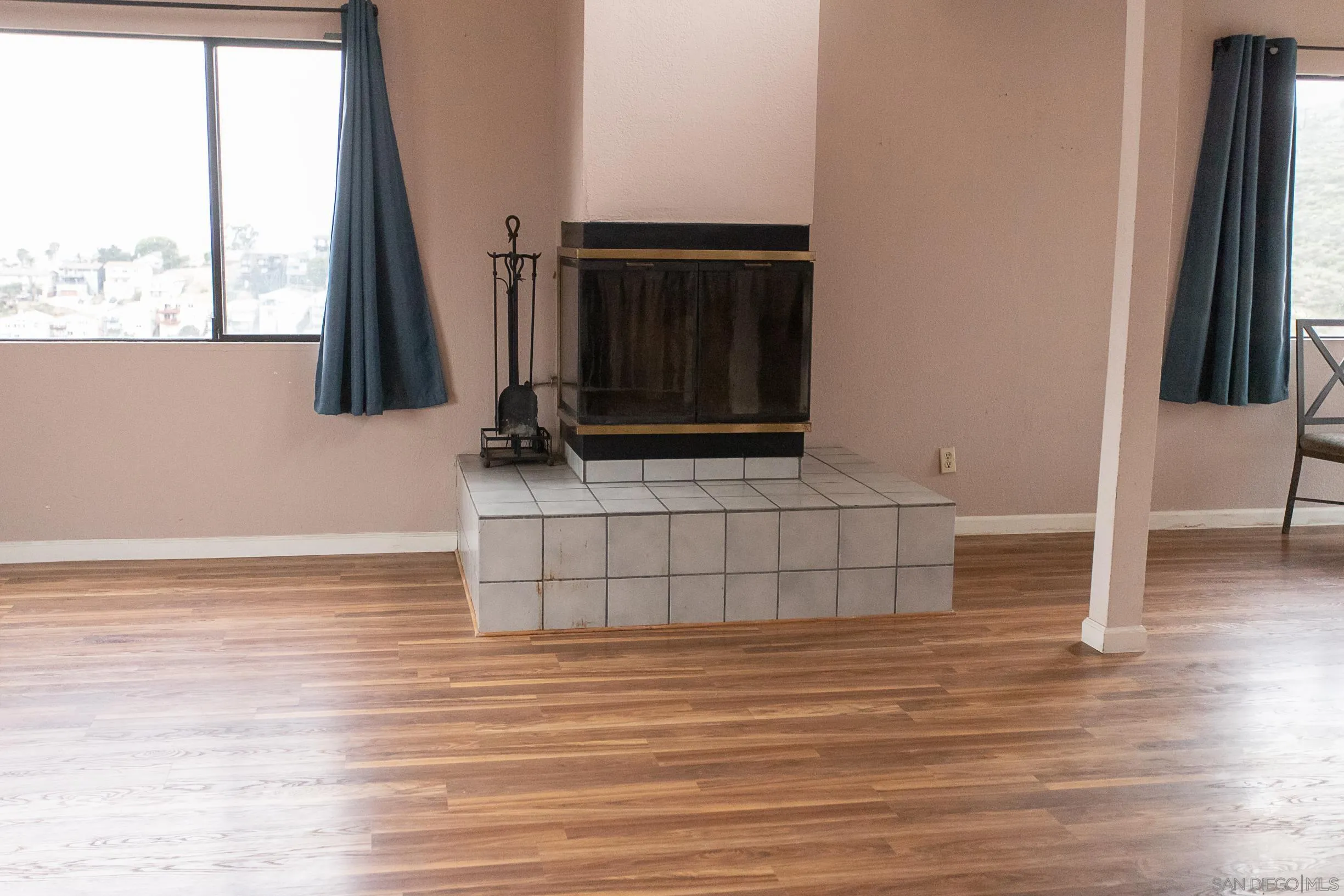 9802 Eucalyptus Street Spring Valley, CA 91977 - Photo 3 of 40 an empty room with wooden floor and windows