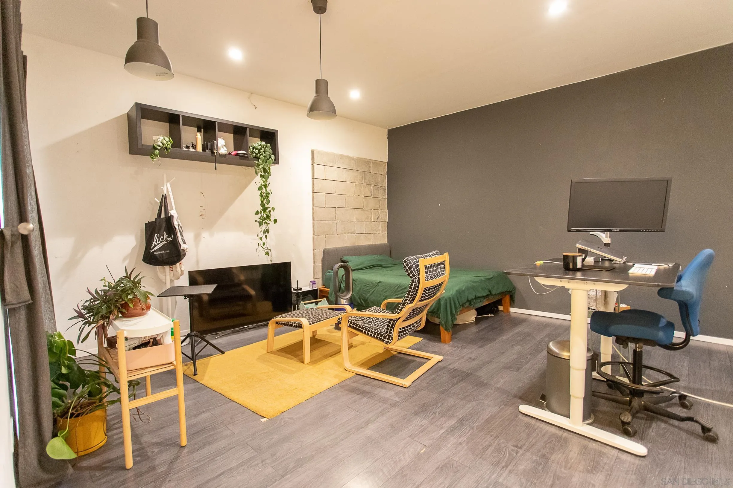 9802 Eucalyptus Street Spring Valley, CA 91977 - Photo 32 of 40 a living room with furniture a rug and a flat screen tv